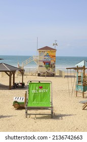 TEL AVIV, ISRAEL - 17.03.2022. Beach with welcome chairs and colored life guard tower.  Giant chairs I Love Tel Aviv and Tel Aviv Loves Me and sea