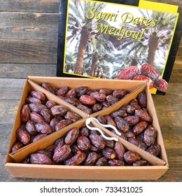 TEL AVIV, ISRAEL - 26 Sept, 2017 : Ripe Date Fruits In A Cardboard Package On The Wood. Sami Dates Medjoul (sort). Paradise Fruits For Healthy Nutrition Of Holy Land