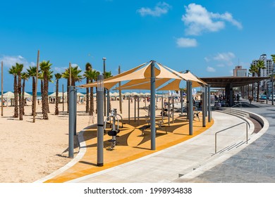 TEL AVIV, ISRAEL - JULY 19, 2017: Promenade along public beach with open air gym on the sand in Tel Aviv -  economic and technological center, second most populous city of Israel.