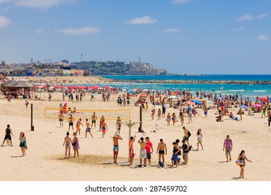 TEL AVIV, ISRAEL - JUNE 12, 2015: View of the beach of Tel-Aviv and the old city of Jaffa, with locals and tourists in Tel-Aviv, Israel.
