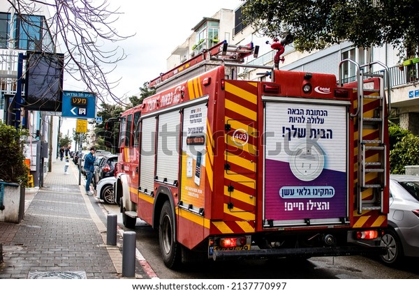 Tel\
Aviv, Israel - March 15, 2022 Fire truck parked in the streets of\
Tel Aviv, firefighters responded to put out a minor fire at the\
entrance to a residential building in the city\
center