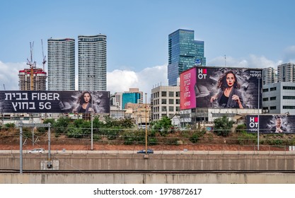 TEL AVIV, ISRAEL - MAY 21, 2021 : Billboards along Ayalon highway over new skyscrapers  at Sarona area. Tel Aviv, Israel.