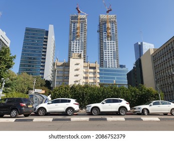 TEL AVIV, ISRAEL. November 23, 2021. A View Of New Modern Skyscrapers Built In Central Tel Aviv, Busy City Street With Cars Parked On The Side. Doubnov Street View.