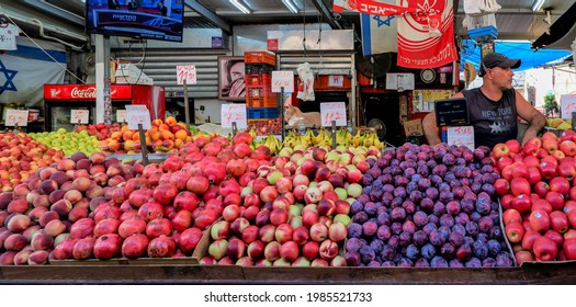 TEL- AVIV, ISRAEL - SEPTEMBER 16, 2019 : Israeli vender and his fruit stall in Carmel Market, Israel