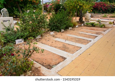 TEL AVIV - OCT. 26, 2019: Empty Burial Lots  At  A Secular Civil And Jewish Cemetery In Israel At The Outskirts Of Tel Aviv.  Hebrew Text Says 