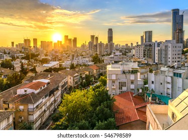 Tel Aviv skyline at sunset. Roof top view. View to the city from suburbs. Old houses and modern buildings.
