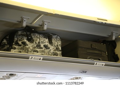 Tel-Aviv/Israel - June 4, 2018: Ben-Gurion Airport and the airplanes of Israeli airline El Al .Three travel bags with hand luggage in the luggage compartment of the aircraft