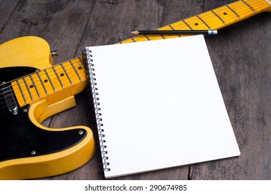 Telecaster With Notepad On Wood Table