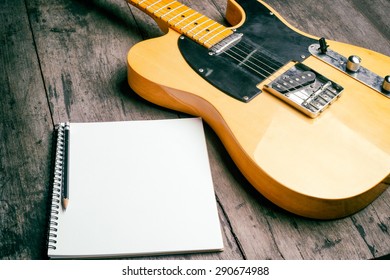 Telecaster With Notepad On Wood Table