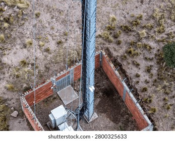 Telecom tower base with steel structure in fenced Andean site
