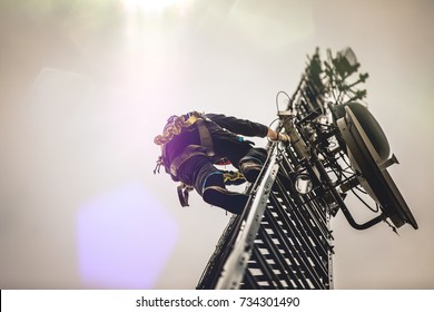 Telecom Worker Climbing Antenna Tower