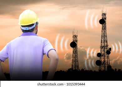 Telecommunication Engineer Looks At Phone Poles