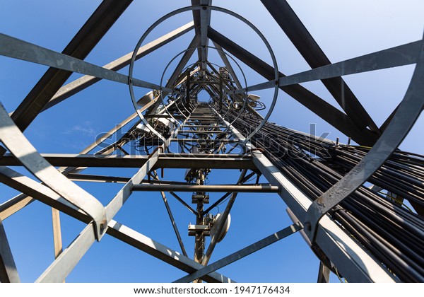 Telecommunication mast with microwave equipment,\
radio panel antennas, outdoor remote radio units, power cables,\
coaxial cables, optic\
fibers