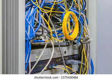 Telecommunication Panel With Random Interweaving Of Wires. Internet Communication Cables Are Connected To Telephony Ip Switches. The Equipment Operates In The Data Center Cabinet Cabinet.