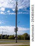 Telecommunication tower with 4G, 5G transmitters. Cell tower against blue sky with clouds