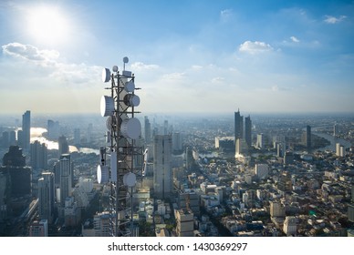 Telecommunication tower with 5G cellular network antenna on city background