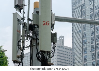 Telecommunication Tower With 5G Cellular Network Antenna In Modern City.