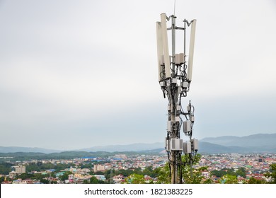 Telecommunication tower with 5G cellular network antenna on A town in the valley background