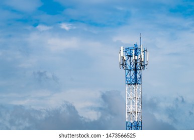 Telecommunication Tower With Blue Sky And White Clouds Background. Antenna On Blue Sky. Radio And Satellite Pole. Communication Technology. Telecommunication Industry. Mobile Or Telecom 4g Network.