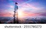 Telecommunication tower with network and city skyline at sunset. 