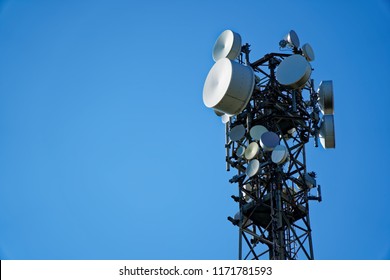 Telecommunication tower with round antenna and clear blue sky on background - Powered by Shutterstock