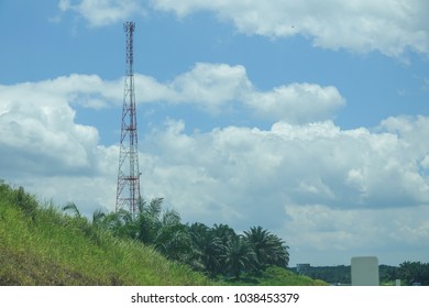 The telecommunication tower in sky with clouds background