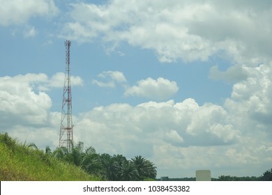 The telecommunication tower in sky with clouds background
