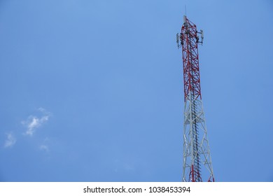 The telecommunication tower in sky with clouds background
