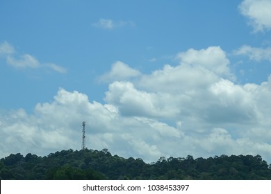 The telecommunication tower in sky with clouds background