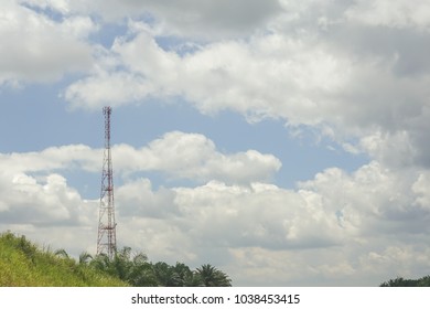 The telecommunication tower in sky with clouds background