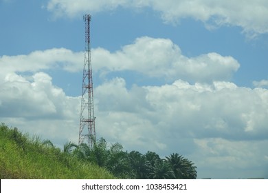 The telecommunication tower in sky with clouds background