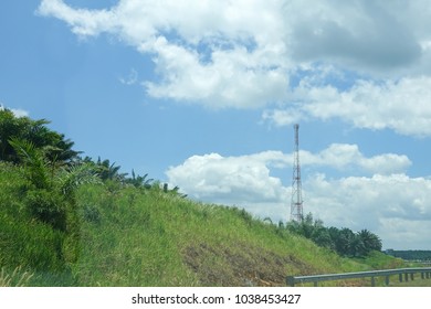 The telecommunication tower in sky with clouds background