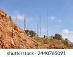 telecommunications antennas on top of a rocky mountain