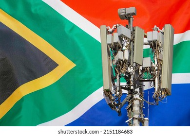 Telecommunications tower with a 5G cellular network antenna agains flag of South Africa. 5G technology usage on telecommunications towers in South Africa