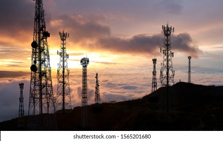 Telecommunications tower antenna and satellite background sunset sky