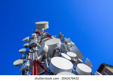 telecommunications tower of different mobile phone, radio and television operators with masts and microwave radio link antennas, 4g and deployment of 5g generation in cities and rural areas
