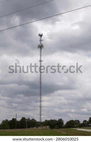 Telecommunications Tower with Integrated Multi-Sector Antenna with a Stormcloud Backdrop