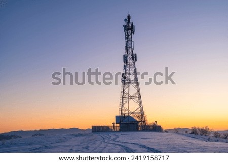 telecommunications tower in a winter mountainous setting