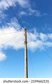 A Telegraph Pole Carrying Telephone Cables To Suburban Houses In A Town In The UK