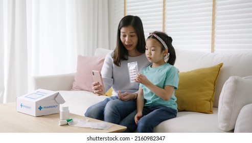 Telehealth Telemedicine Care Mobile App Exam Visit Service Asia People. Worry Mom And Sick Kid Girl Ask Doctor In Video Call Talk VoIP Clinic Self Cure With Cold Flu Rx Box Pill At Sofa Home Isolate.