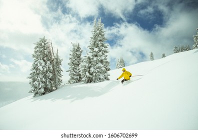 A telemark skier skiing in Vail Back Bowls, a cold winter day in Vail, Colorado, USA
