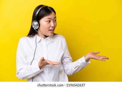 Telemarketer Chinese Woman Working With A Headset Isolated On Yellow Background With Surprise Facial Expression