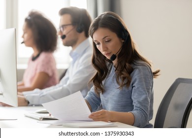 Telemarketing representative or sales agents sitting at workplace wearing headset use computer, focus on call center member millennial female read document paper, helpline office, busy workday concept