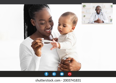 Telemedicine And Children Healthcare Concept. Smiling Young African American Woman Making Remote Videocall With Pediatrician Doctor Looking At Thermometer Holding Little Black Baby On Hands At Home