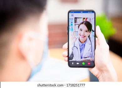 Telemedicine Concept -  Asian Female Doctor Explain About Disease To The Male Patient By Video Chat With Smartphone