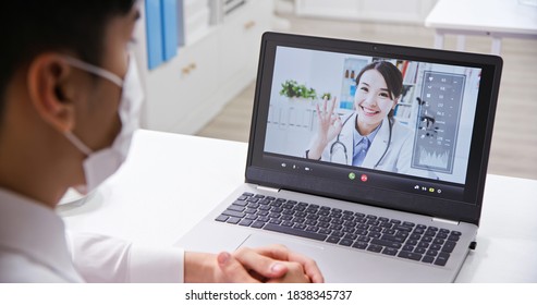 Telemedicine concept - asian male businessman patient has video call with female doctor on laptop in office