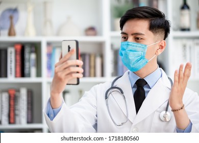 Telemedicine Concept -  Asian Male Doctor Explain To The Patient About The Disease By Video Chat On Cell Phone