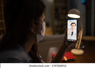 Telemedicine Concept -  Asian Male Doctor Explain About Disease To The Patient By Smartphone Video Chat With Ok Gesture