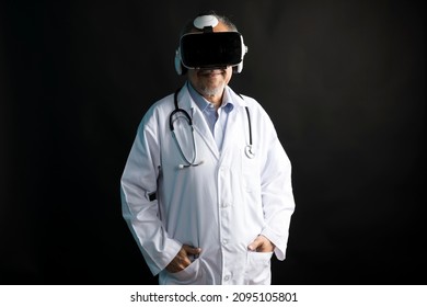 Telemedicine concept, old Asian doctor in lab uniform wearing VR glasses and operating medical task standing  on black background. - Powered by Shutterstock