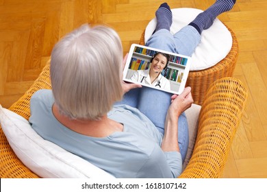 Telemedicine Concept, Old Woman With Tablet Pc During An Online Consultation With Her Doctor In Her Living Room.